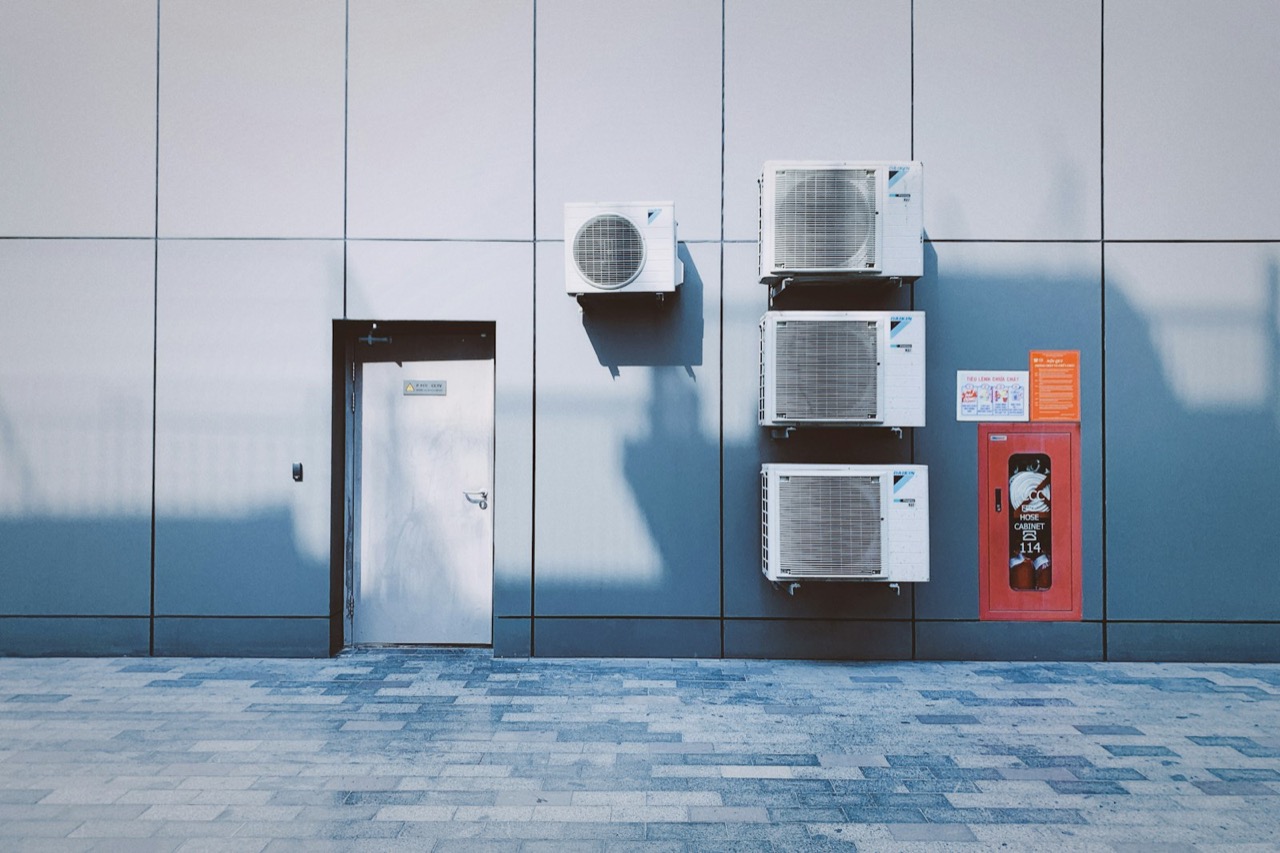 Modern air conditioning condenser units installed on an exterior wall