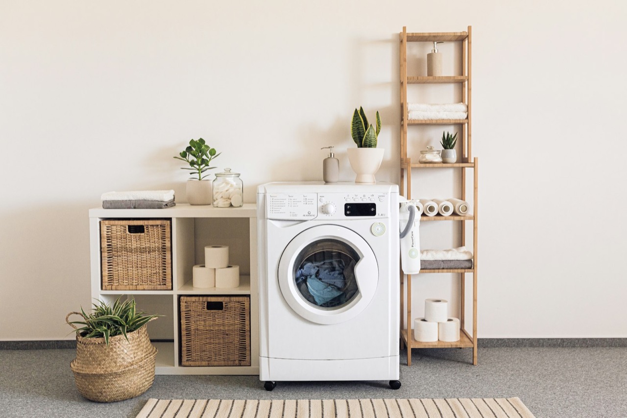 A bright laundry room with a modern washing machine