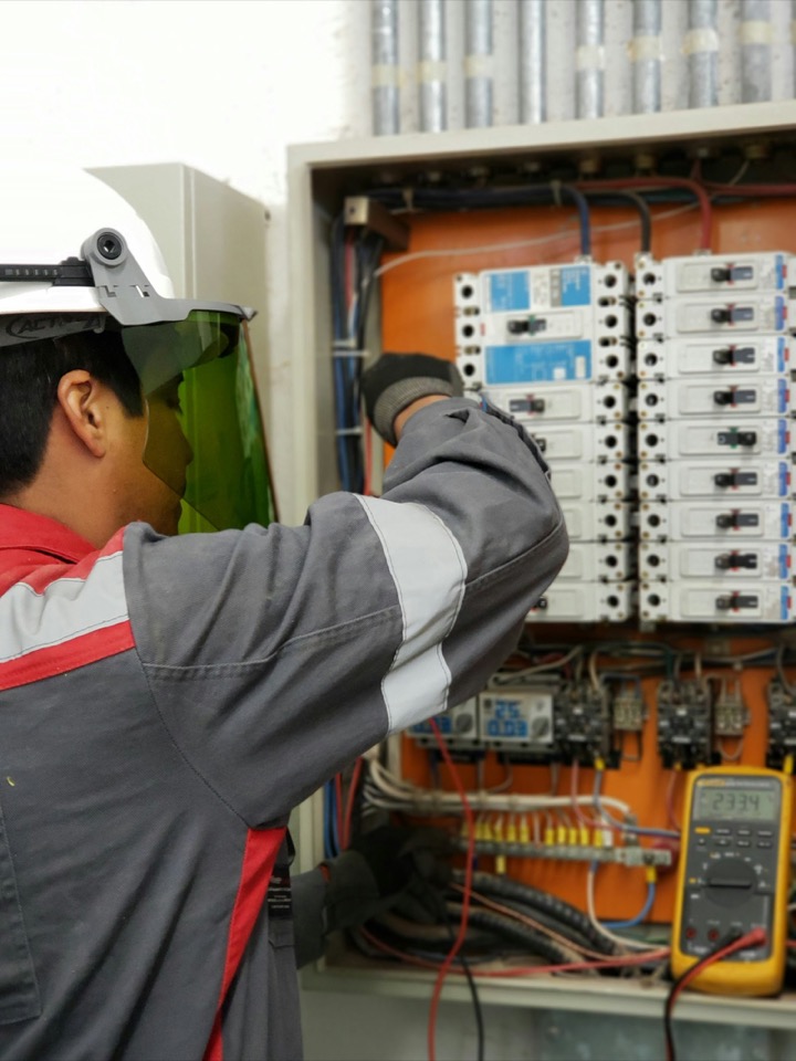 A technician inspecting equipment during a repair visit